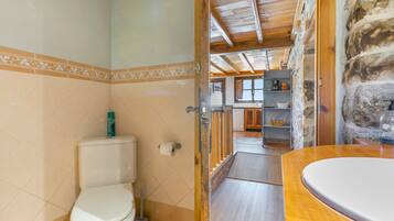 A bathroom with a toilet, a bidet, and a sink.