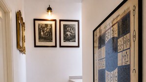 A staircase with a light fixture above and framed artwork on the walls. - Private villa with infinity pool, Hot Spring hot tub and views in Mijas (Mijas)