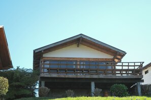 A two-story wooden building with a balcony on the upper floor.