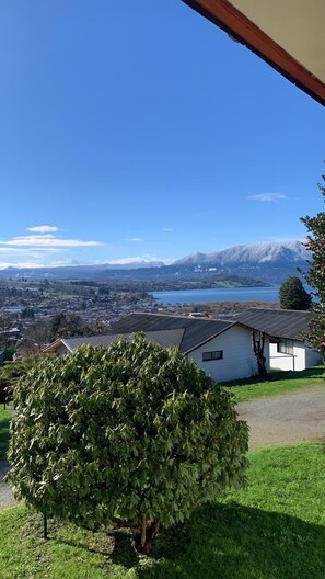 A residential area with a view of a lake and mountains.