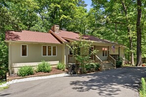 A single-story house with a red roof, a front porch, and a flag. - Lake Hartwell Retreat w/Dock & Lake Access, Foosball, Ping Pong, Mini Golf & BBQ (Lavonia)