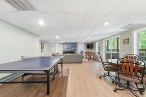 A spacious indoor area with a ping pong table, a foosball table, and a dining table with chairs. - Lake Hartwell Retreat w/Dock & Lake Access, Foosball, Ping Pong, Mini Golf & BBQ (Lavonia)