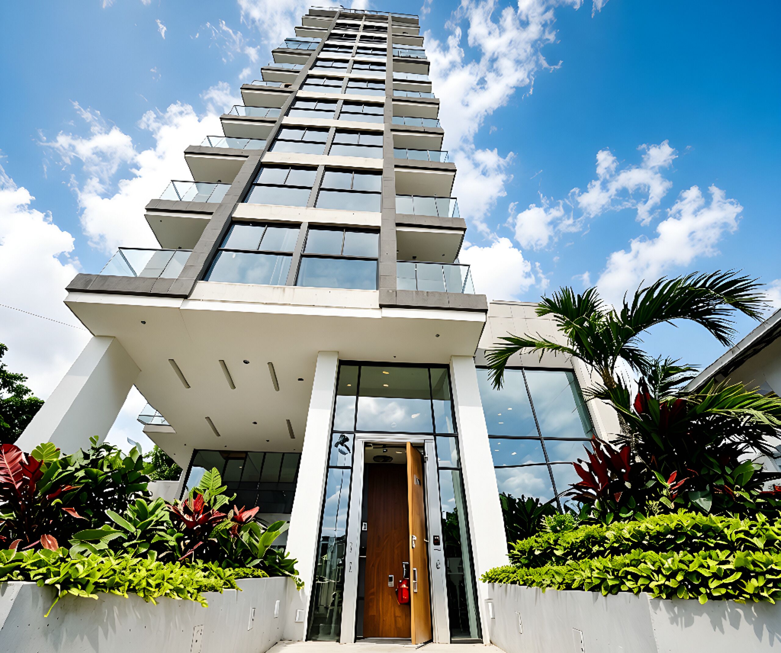 A modern high-rise building with a prominent entrance and a glass facade.