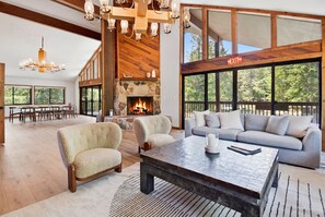 A spacious living room with a fireplace, a large sofa, and a coffee table. - Near Canyons Ski Lift w/ Communal Hot Tub (Park City)