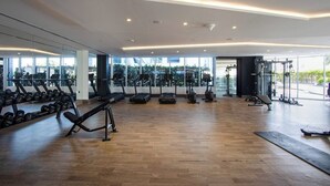 A spacious gym with treadmills, dumbbells, and weight machines. - Modern Studio with Private Pool and Balcony (Dubai)