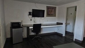 A compact office space with a kitchenette, a desk, and a chair. - Del Rancho Motel (Portland)