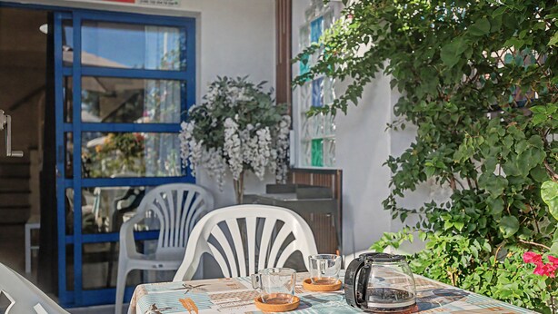 An outdoor seating area with a table set for two, a coffee pot, and a glass pitcher. -  'Casa Romantico - Playmar' with Shared Pool, Private Terrace and Wi-Fi (Maspalomas)