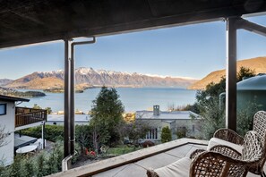 A balcony with a view of a lake and mountains. - Aspen Ridge by MajorDomo | Fernhill Villa with Lake Views, Infrared Sauna, Spa Pool & Outdoor Fireplace (Queenstown)