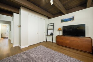 A room with a wooden ceiling, a white wardrobe, a television on a wooden cabinet, and a framed picture on the wall. - Waterfront Tahoe Keys Condo. Private Boat Dock, Lake Views & Family Friendly (South Lake Tahoe)