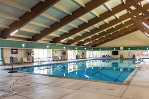 An indoor swimming pool with clear lanes, a tiled floor, and a high ceiling with wooden beams. - Waterfront Tahoe Keys Condo. Private Boat Dock, Lake Views & Family Friendly (South Lake Tahoe)