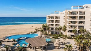 A resort with a pool, beach, and ocean view. - Beachfront Luxury 3 BR Condo in Diamante Dunes (Cabo San Lucas)
