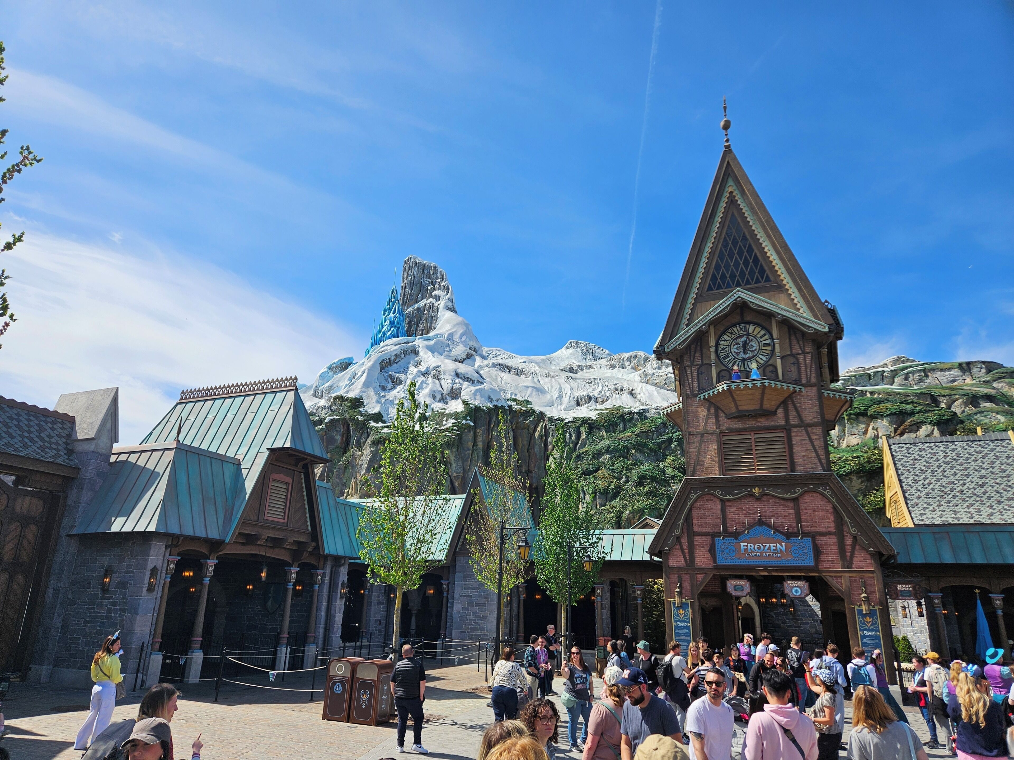 A building with a clock tower and a sign that reads 'Frozen.'