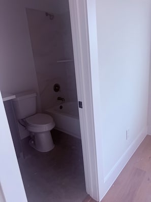 A bathroom with a toilet, a bathtub, and a shower. - Emancipation/ TSU/UofH New Build  4-bedroom 3-story townhome in Houston (Houston)