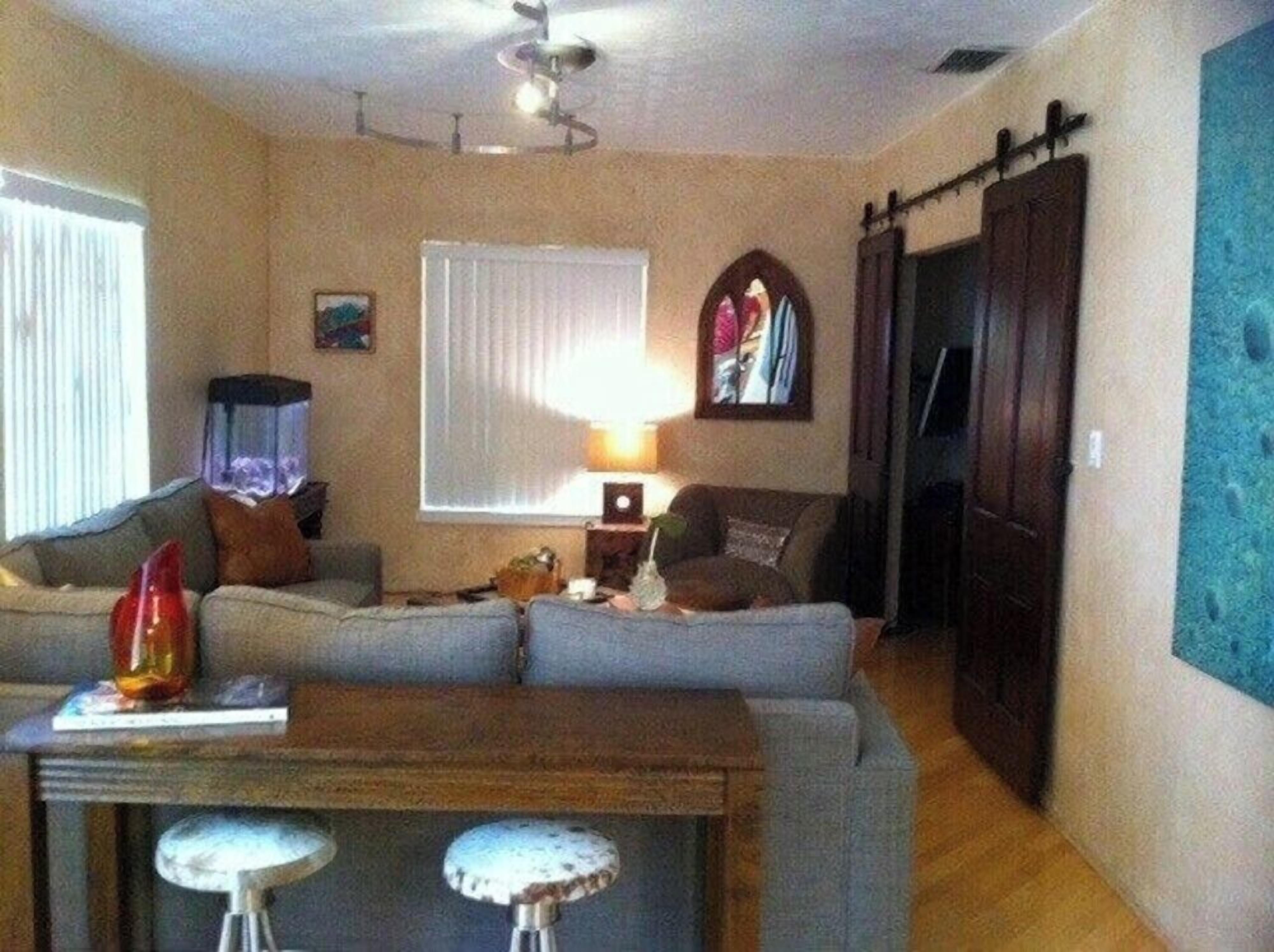 A living room with a sofa, a coffee table, and a lamp.