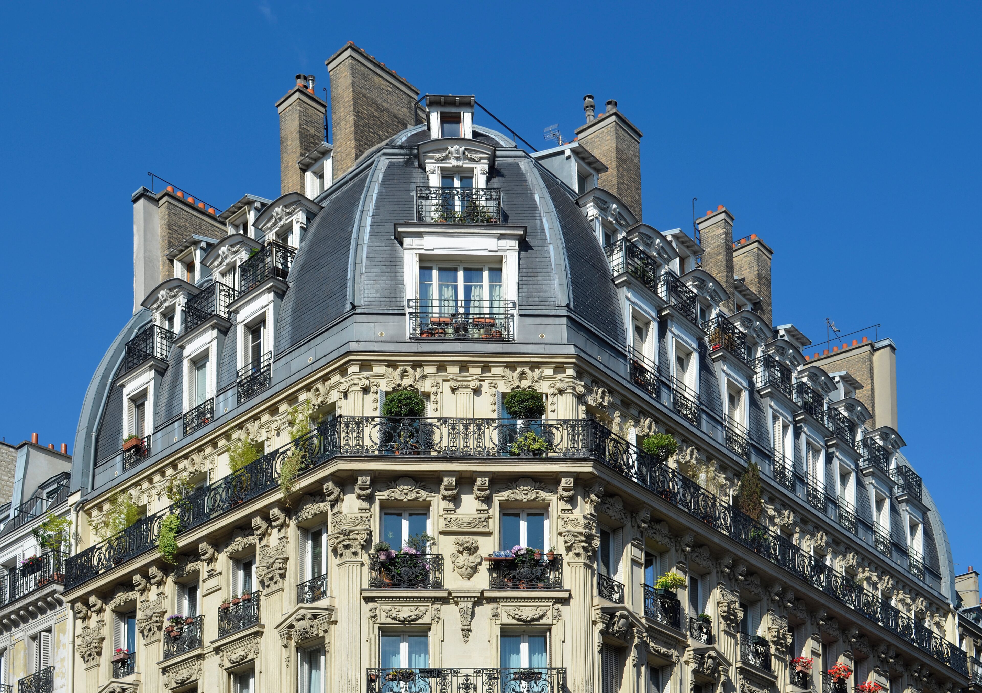 A multi-story building with ornate balconies and a classic architectural style.