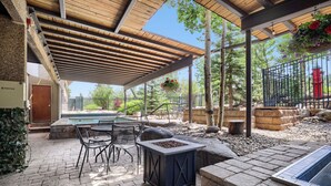 An outdoor patio with a pool table, seating, and a fire pit. - Freshly Updated Ski-In Ski-Out 2BR Beaver Run (Breckenridge)