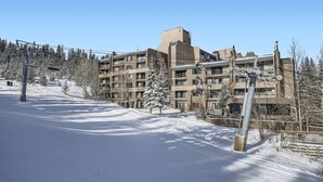 A snow-covered ski slope with a multi-story building in the background. - Freshly Updated Ski-In Ski-Out 2BR Beaver Run (Breckenridge)