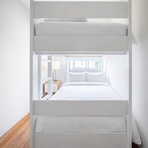 A bunk bed with a window above the lower bunk, a bedside table, and a lamp. - 3 APTS in One Building · Ideal for Large Groups! (Miraflores)