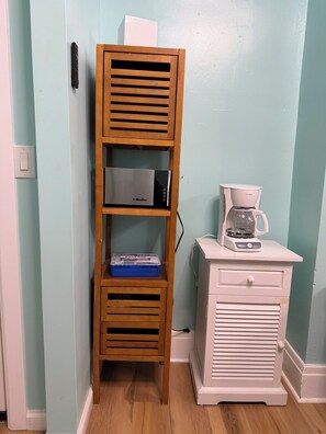 A wooden shelf unit with a coffee maker and a drawer unit against a light blue wall. - MRSP 07 Luxury Family Home Near Niagara Falls (Niagara Falls)