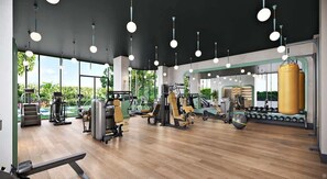 Ein modernes Fitnessstudio mit unterschiedlichen Trainingsgeräten, großen Fenstern und Holzboden.