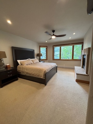 A bedroom with a bed, nightstands, a ceiling fan, and windows. - Ski-In/Ski-Out Luxury Townhome Renovated 2026 Bunk Room + Game Level (Beaver Creek)