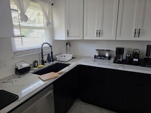 A kitchen with white cabinets, a sink, a coffee station, and a window with blinds. - 3BR 2B Short/Long term Available! Ventnor Heights Home/Back Yard, Walk to Beach! (Ventnor City)