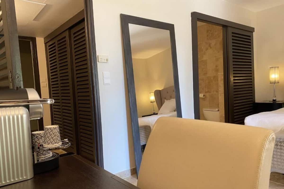 Junior Double Room, Patio, Garden View | In-room safe, desk, iron/ironing board (on request), WiFi (free)