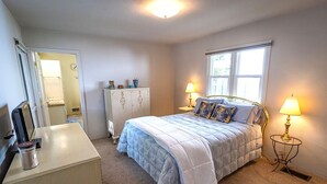 A bedroom with a bed, bedside lamps, a dresser, a wardrobe, and a window. - 10-Min Walk to Downtown & Lake • 10-Min Drive to Schweitzer Base (Sandpoint)