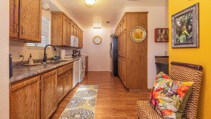 A kitchen with wooden cabinets, a microwave, and a refrigerator. - General Sherman Loft ~ 2 min from Sequoia Nat’l Park (Three Rivers)