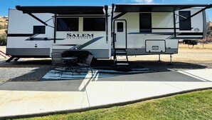 A recreational vehicle named 'Salem Hemisphere' parked on a concrete pad with a clear sky in the background. - 2-bedroom recreational vehicle in lovely Exeter with AC (Exeter)