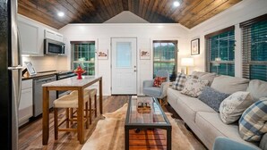 A compact living space with a kitchen, dining area, and seating area. - Private Ranch - 27 Acres - Two Private, Secluded Cabins (Broken Bow)