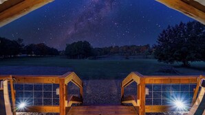 A wooden deck with a view of the night sky, including stars and the Milky Way. - Private Ranch - 27 Acres - Two Private, Secluded Cabins (Broken Bow)