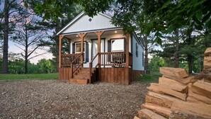 A wooden cabin with a porch, steps, and a gravel driveway. - Private Ranch - 27 Acres - Two Private, Secluded Cabins (Broken Bow)