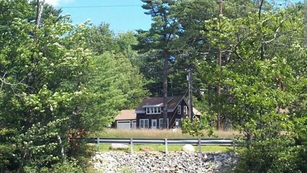 A house surrounded by trees and a stone wall. - Lakes Region Family Getaway& Pet Friendly (Belmont)