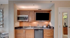A compact kitchen with a microwave, toaster, and dishwasher. - MGM Signature-23-619 Strip View Jacuzzi Studio (Las Vegas)