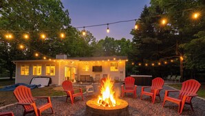 A backyard with a fire pit, outdoor seating, and string lights. - Unwind In Pocono Getaway W/Hot Tub & Game Room Near Kalahari, Camelback, Casino (Albrightsville)
