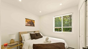 A bedroom with a bed, a bedside table, a lamp, a window with blinds, and a picture on the wall. - Unwind In Pocono Getaway W/Hot Tub & Game Room Near Kalahari, Camelback, Casino (Albrightsville)