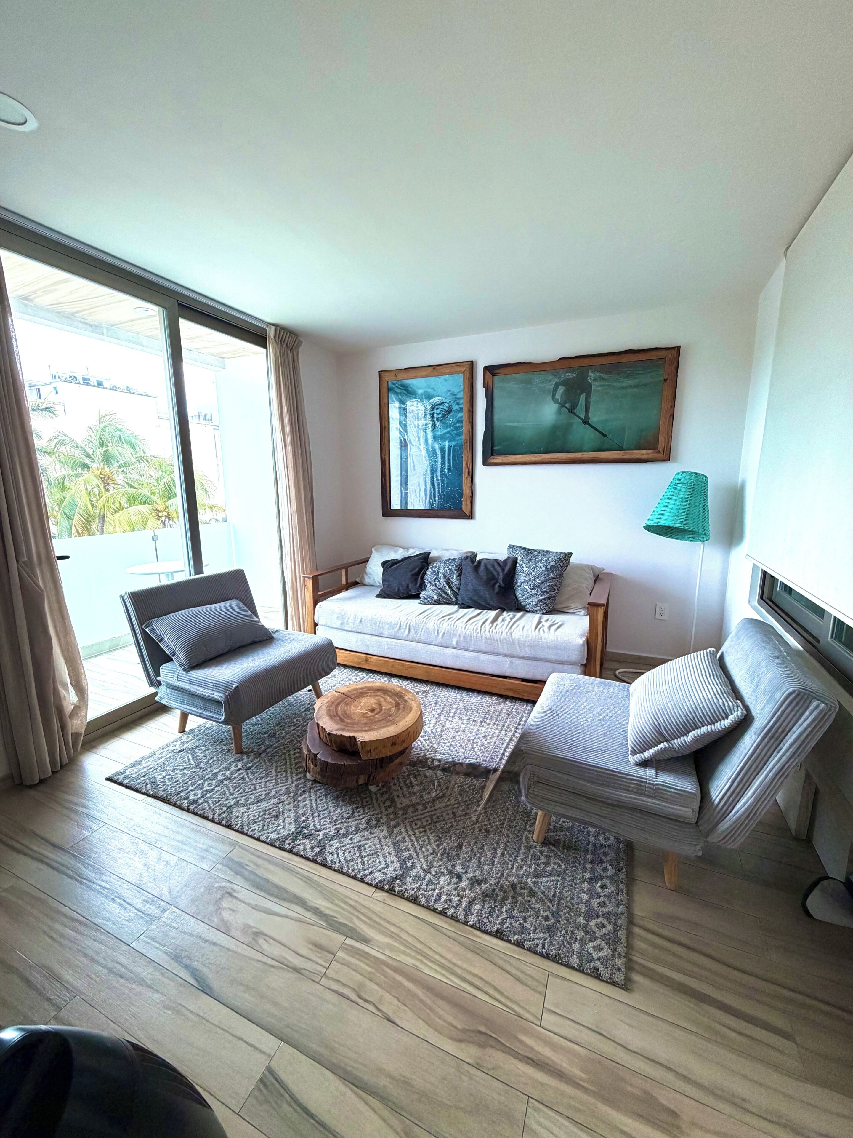 A modern living room with a sofa, two armchairs, a coffee table, and a floor lamp.