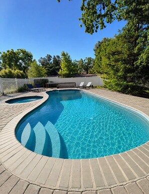 A swimming pool with a curved edge and a tiled deck. - Off-Grid Hidden Oaks Private Retreat (Atascadero)