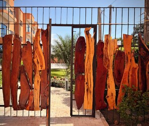 A metal gate with large wooden planks hanging on it.