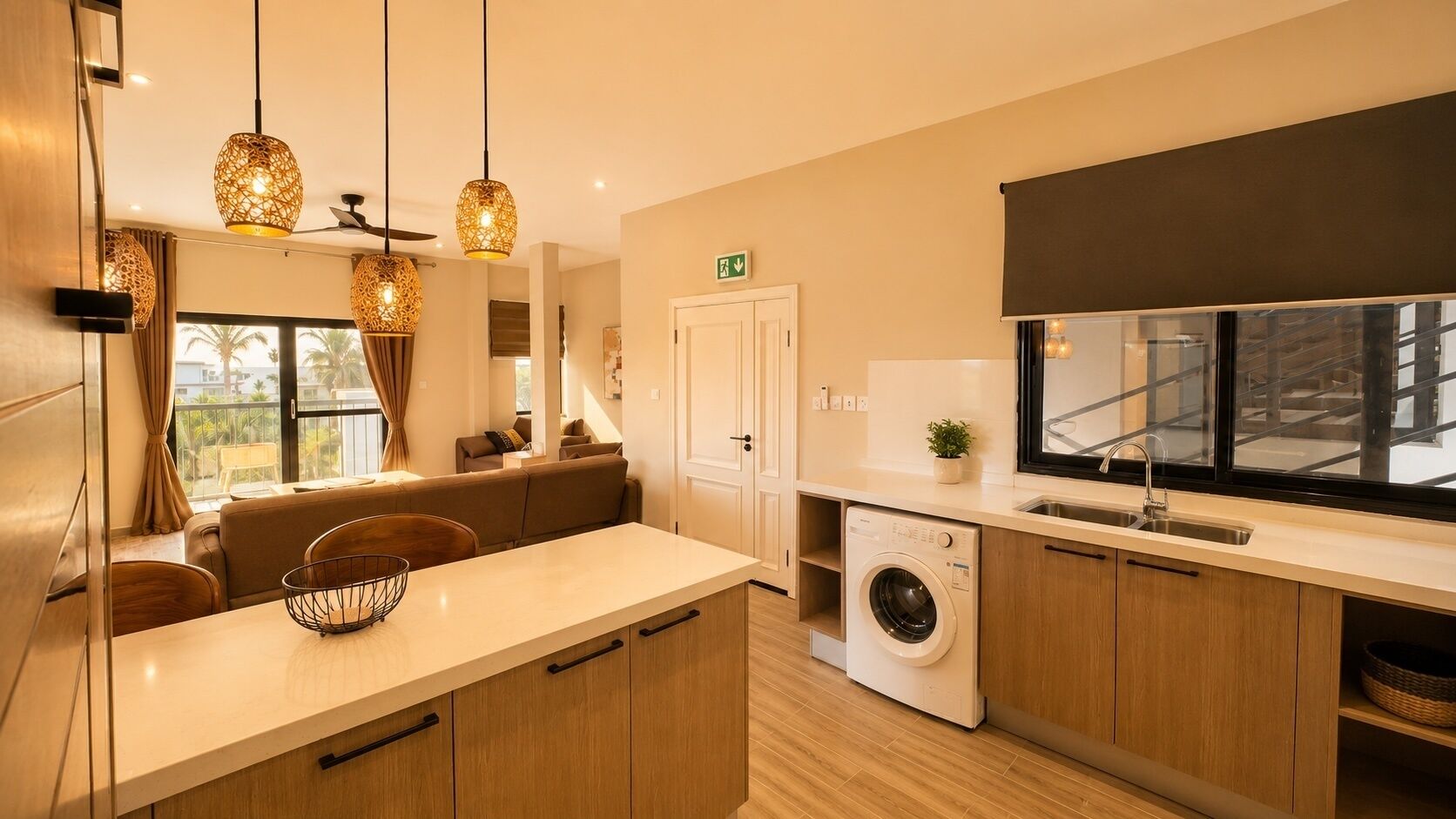 A modern kitchen with a built-in washing machine, wooden cabinets, and pendant lighting.