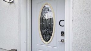 A white door with a glass panel and a keypad lock. - Private King Suite - Springfield METRO (Springfield)