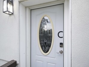 A white door with a glass panel and a keypad lock. - Private King Suite - Springfield METRO (Springfield)