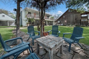 A patio with outdoor furniture, a table, and chairs. - Lakefront Escape, Dock Fire Pit, Grill, SUPs, Kayaks, Large Yard, Pet-Friendly (Seguin)