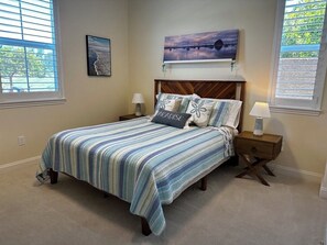 A bedroom with a bed, nightstands, a headboard, and artwork on the walls. - Relaxing getaway next to award winning golf course (Nipomo)