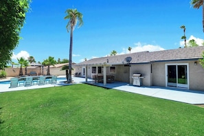 A residential property with a swimming pool, patio furniture, and a covered outdoor seating area. - Desert Retreat with Private Pool & Spa | Near Downtown Palm Springs (Palm Springs)