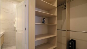 A walk-in closet with open doors, revealing shelves and hanging space. - w* | Designer 2BR Stay w/ Balcony in Miraflores (Lima)