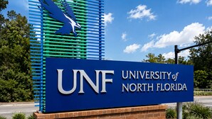 A sign for the University of North Florida with a blue background and white lettering. - Serene Mins 2 Sand Beach Brookdale Mayo Clinic Everbank (Jacksonville)