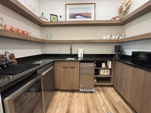 A compact kitchen with a refrigerator, microwave, and coffee maker. - RollingTetonRetreat_Hot tub_Sauna_Patio_FamilyFriendly (Tetonia)