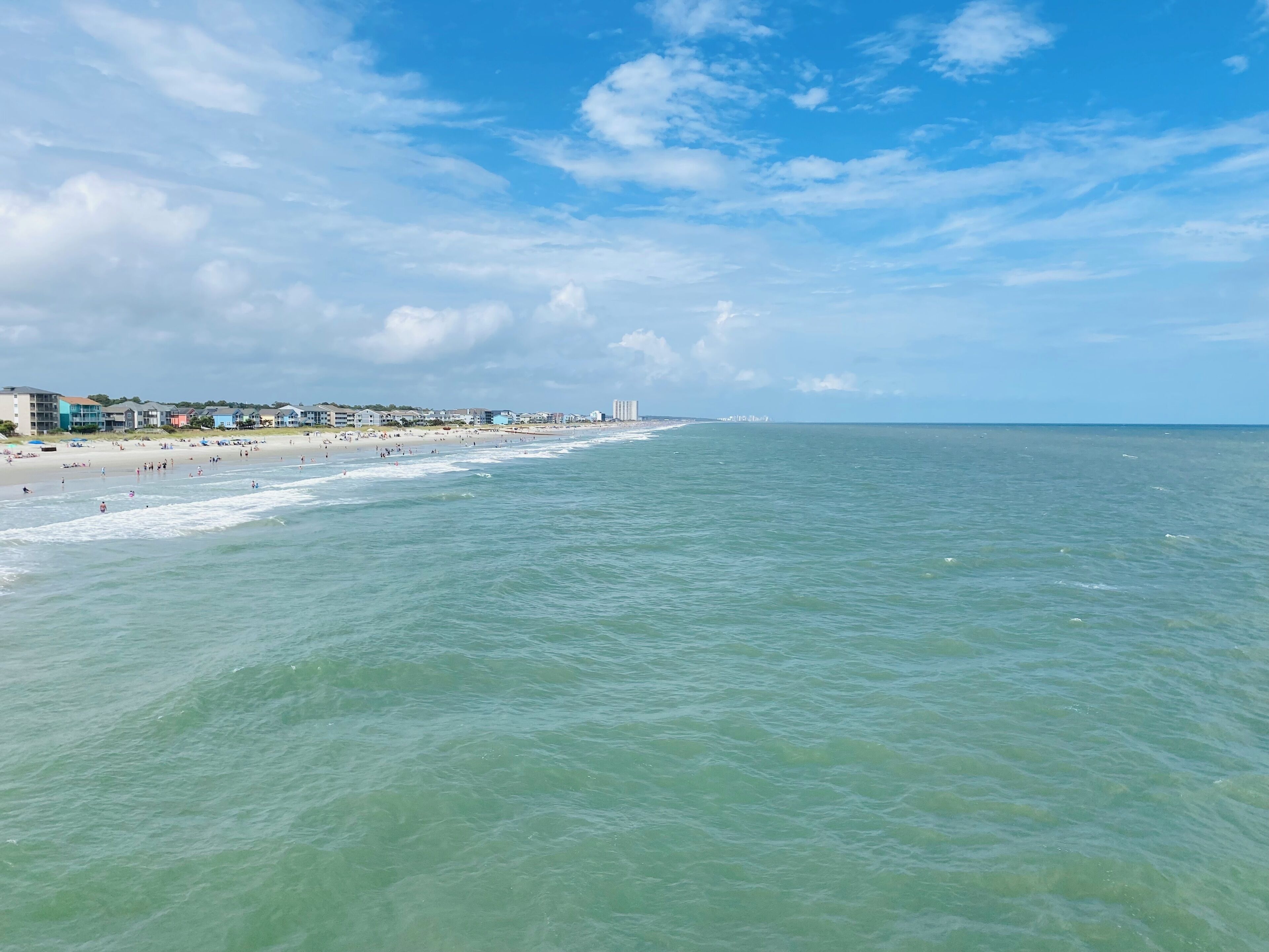 A beach with buildings in the background.